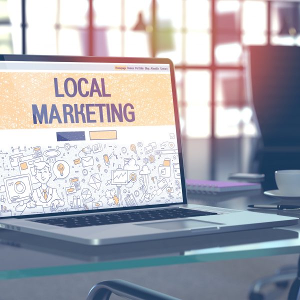 Local Marketing Concept on Laptop Screen. Local Marketing Concept. Closeup Landing Page on Laptop Screen in Doodle Design Style. On Background of Comfortable Working Place in Modern Office. Blurred, Toned Image. 3D Render.